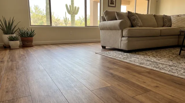 Wood-look laminate flooring in a Phoenix living room with saguaro cactus outside the window