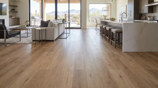 Light oak luxury vinyl plank flooring through an open kitchen and living room with mountain views